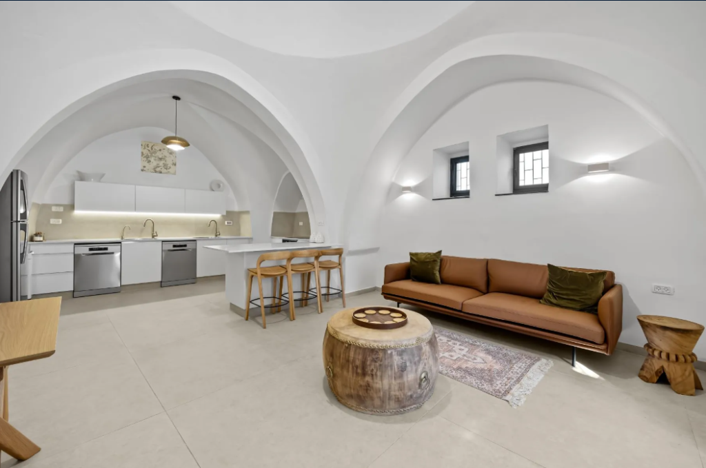 luxury old city jerusalem apartment living room with arched ceilings and kitchen