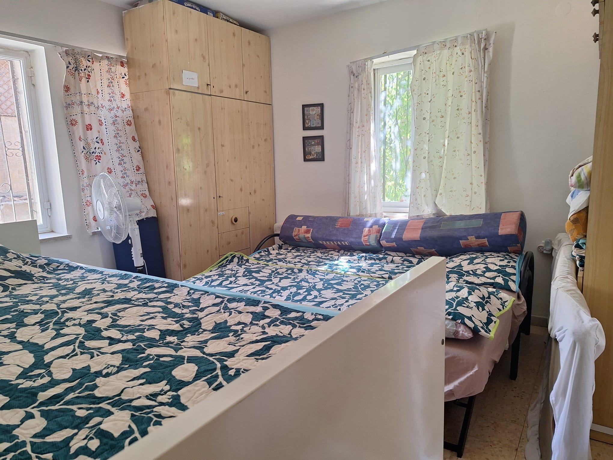 Bedroom with multiple beds in Old City Jerusalem apartment
