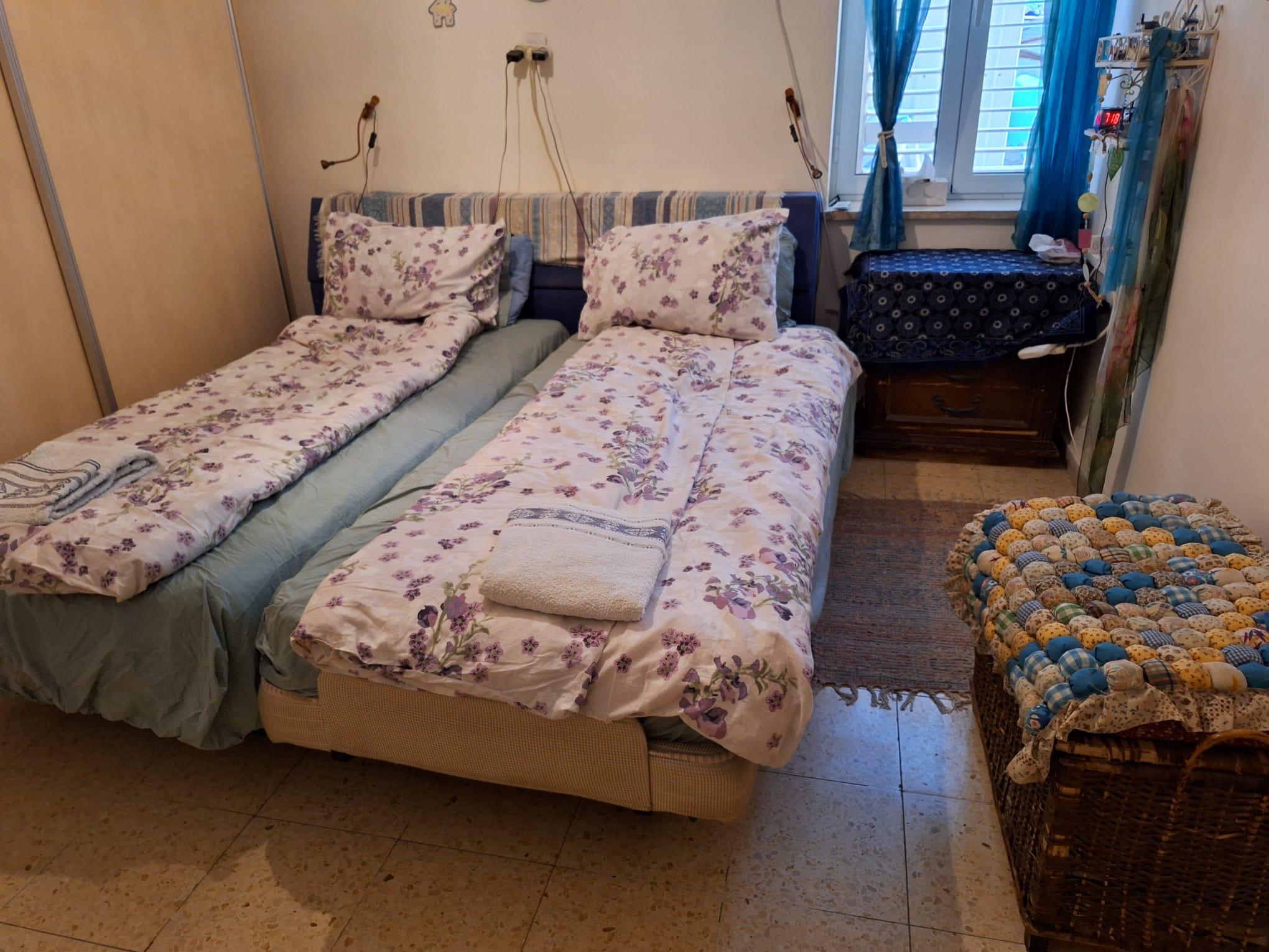 Bedroom with twin beds and window in Old City apartment