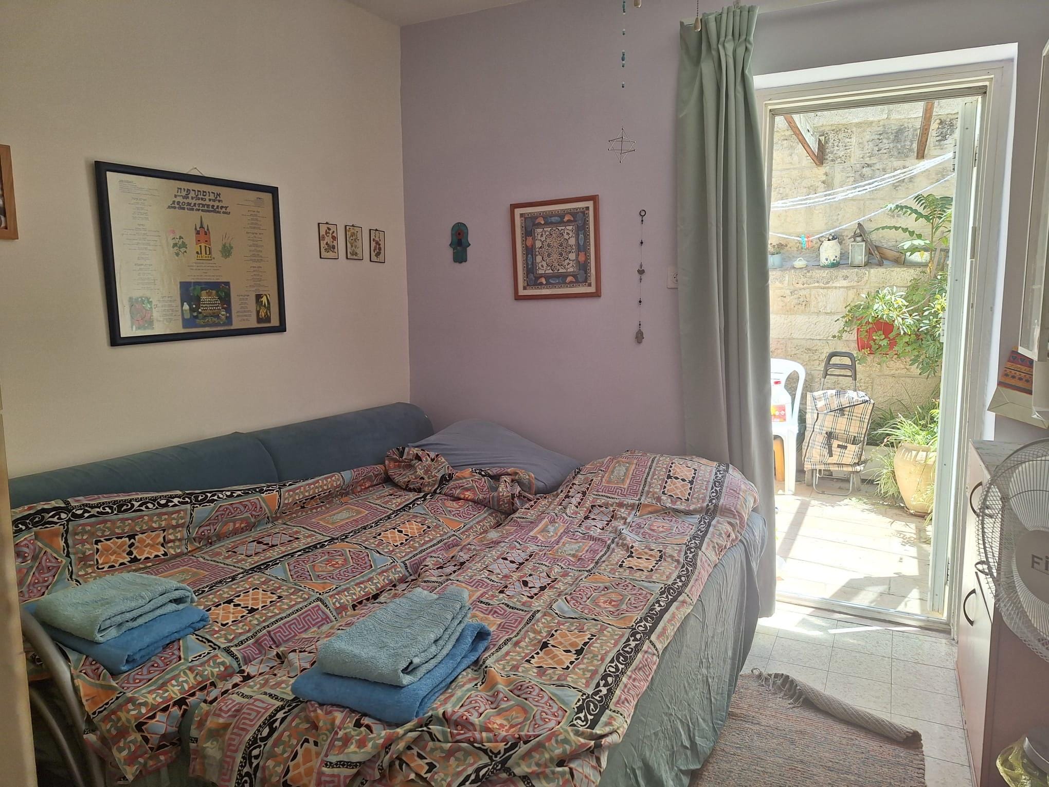 Bedroom opening to private patio in Old City apartment