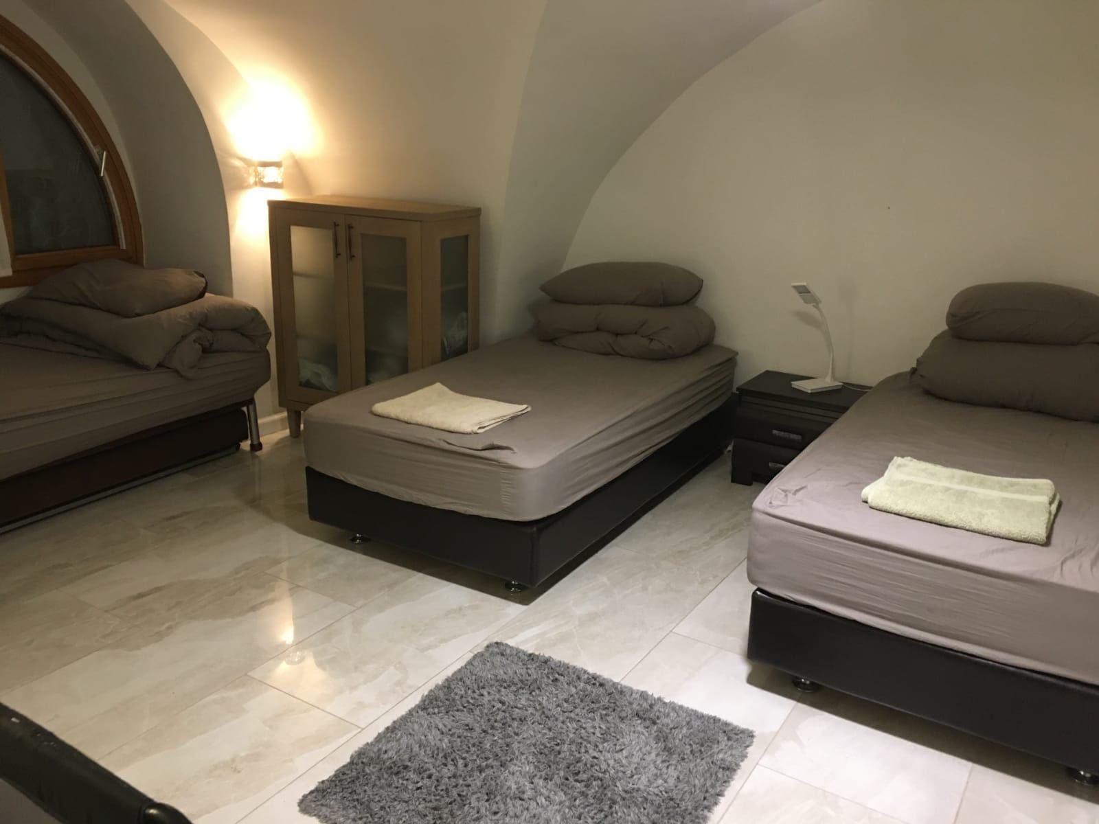 Bedroom with twin beds in Old City Jerusalem apartment