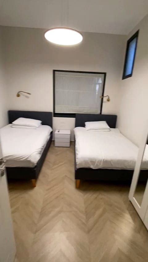 Bedroom with two separate beds in the 2 bedroom KKL Street Shaarei Chessed vacation rental