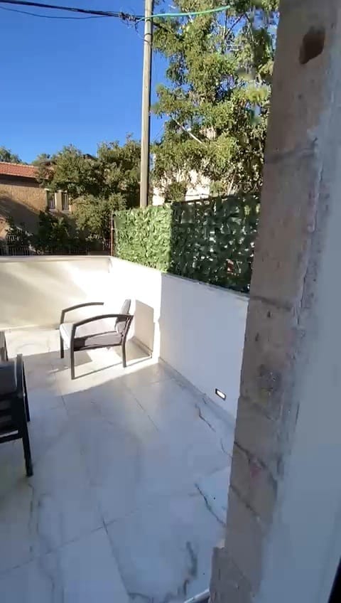 Private outdoor balcony patio at the 2 bedroom KKL Shaarei Chessed vacation rental