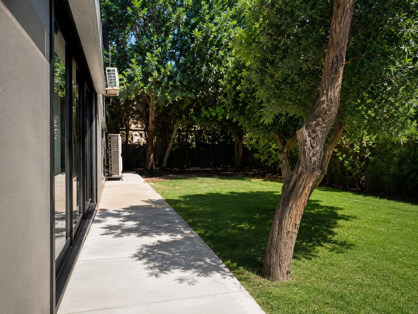 Shaded side walkway beside the private garden at the Ramban Luxury Rechavia apartment