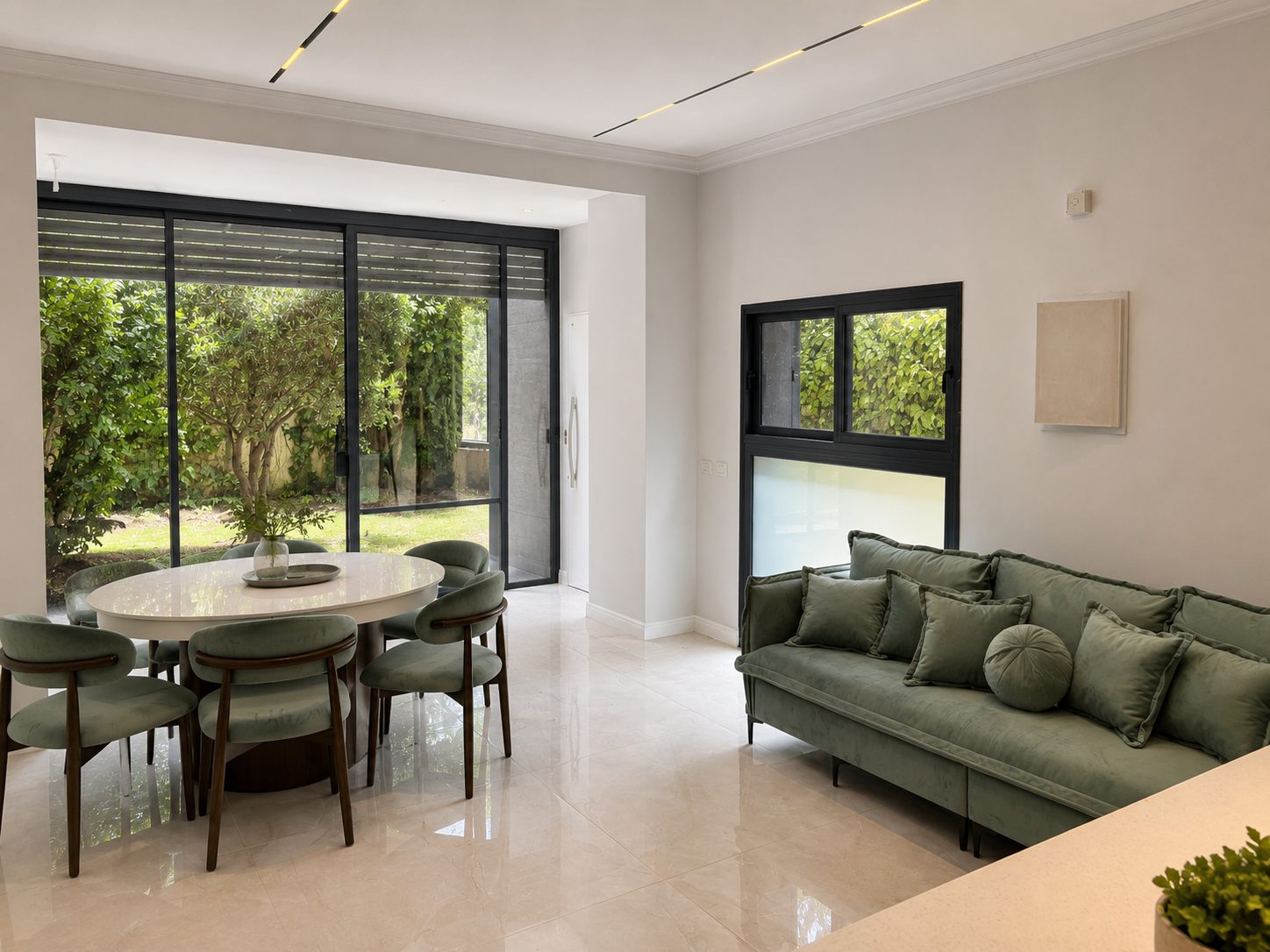 Sunlit Jerusalem apartment living and dining area overlooking a private garden