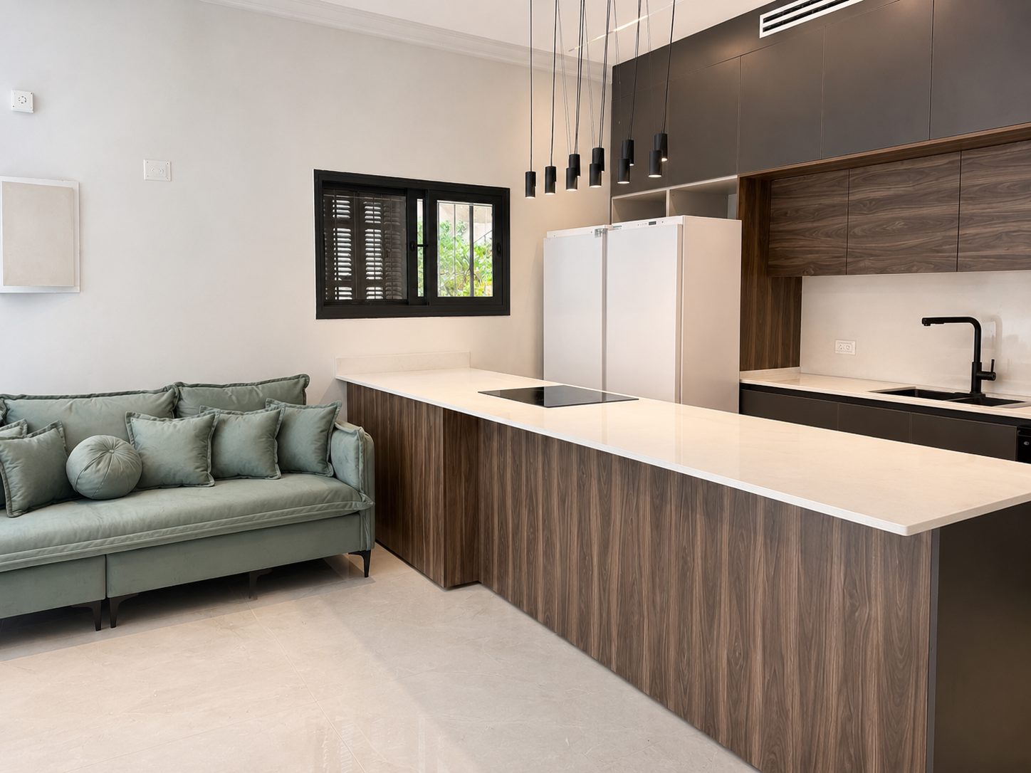 Modern kitchen overlooking the living area in the Ramban Luxury Rechavia apartment