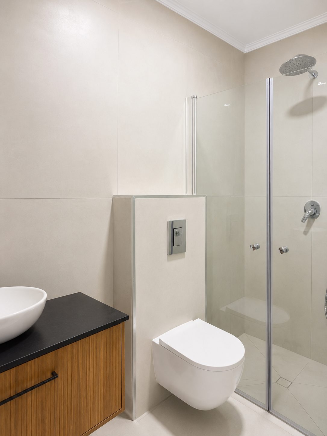 Modern bathroom with vanity and glass shower in the Ramban Luxury Rechavia apartment