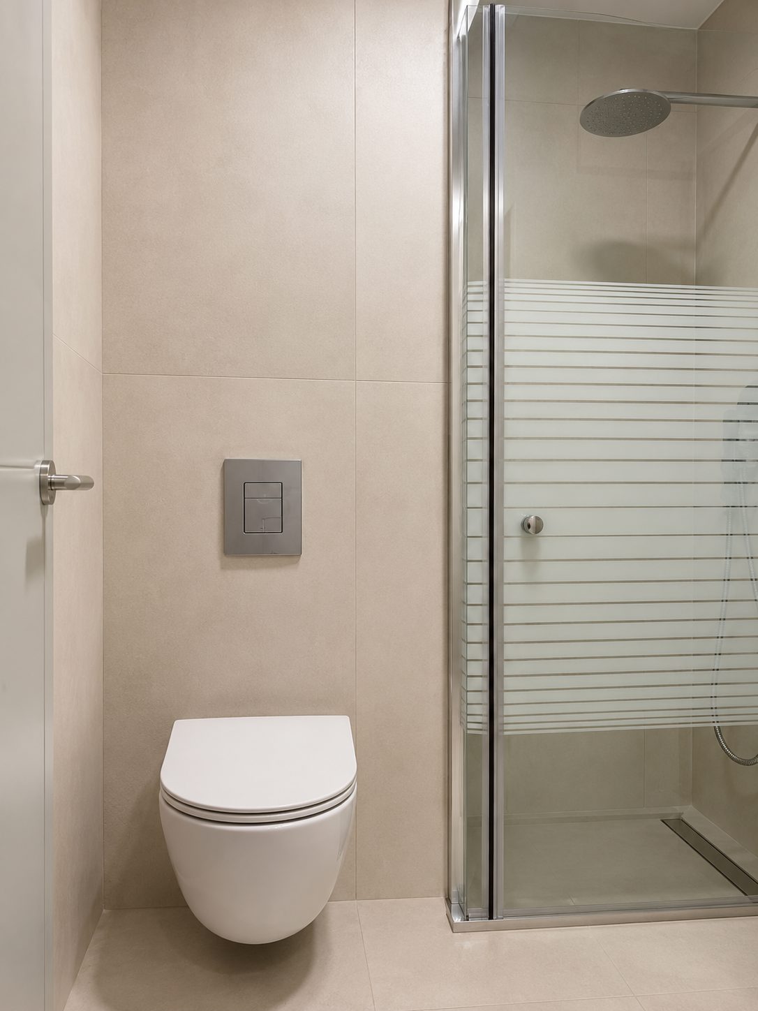 Modern bathroom with toilet and glass shower in the Ramban Luxury Rechavia apartment