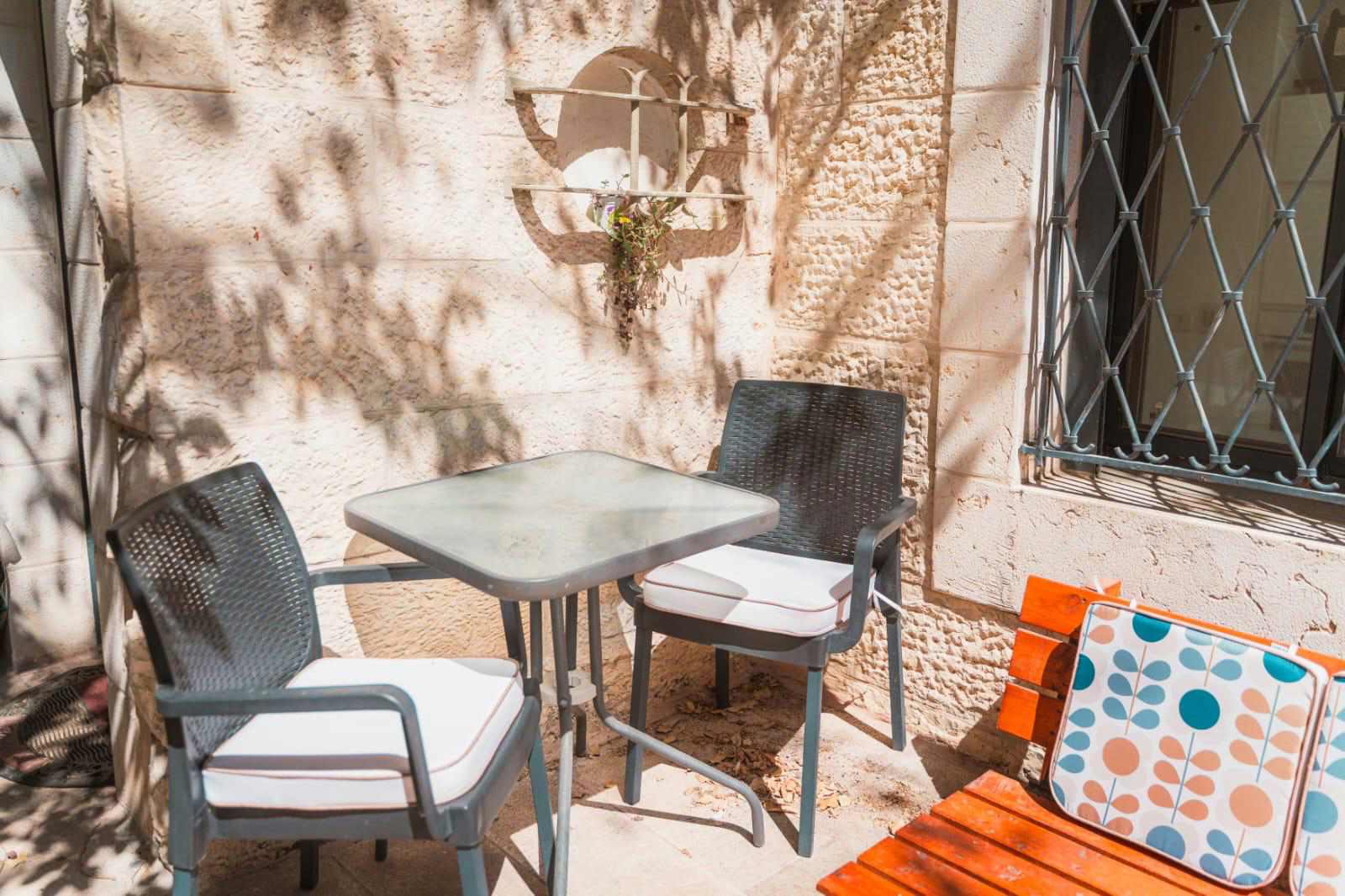 Courtyard seating at the Ben Maimon Rechavia apartment