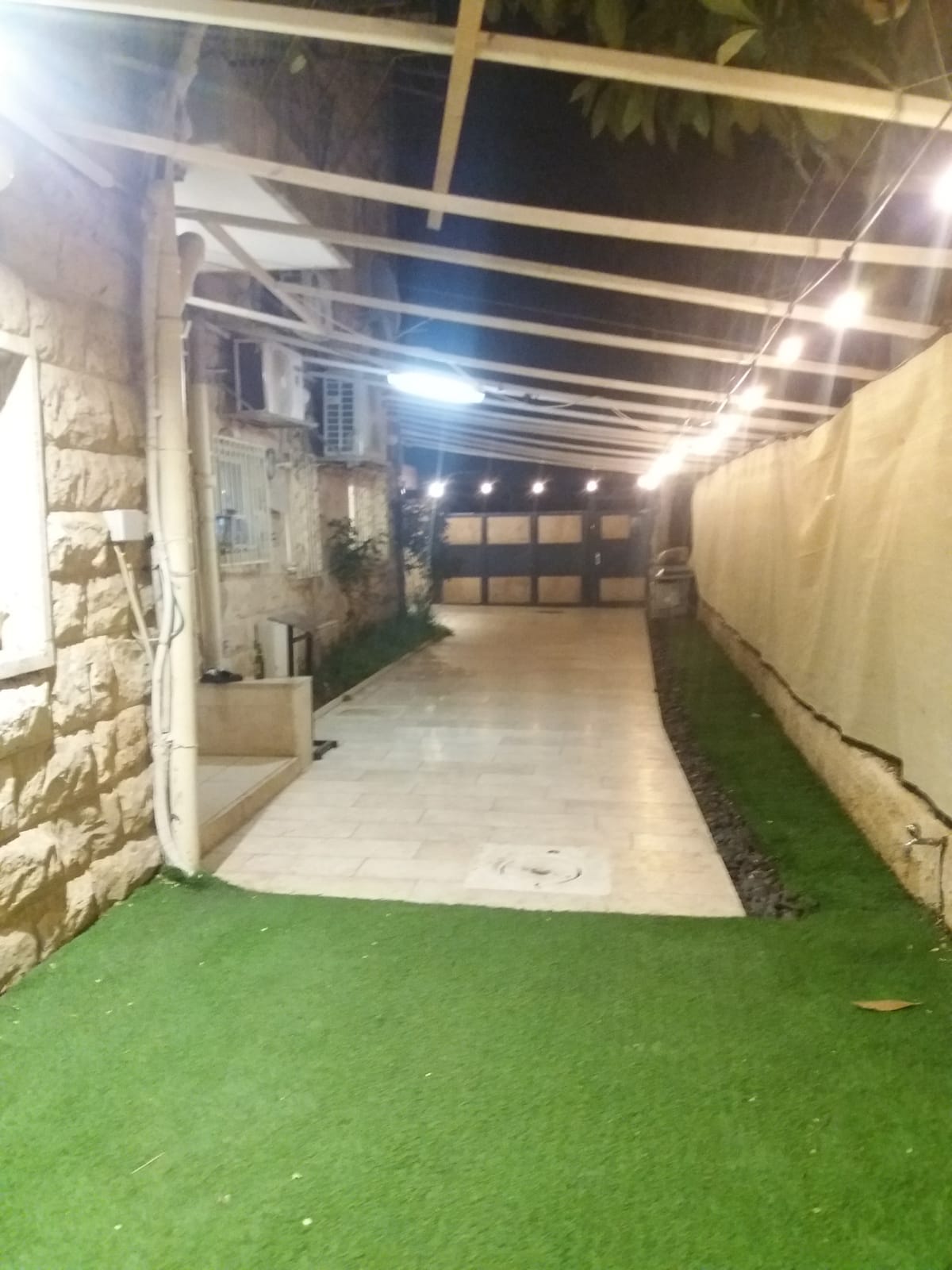 Covered sukkah area at the Ramban Rechavia apartment