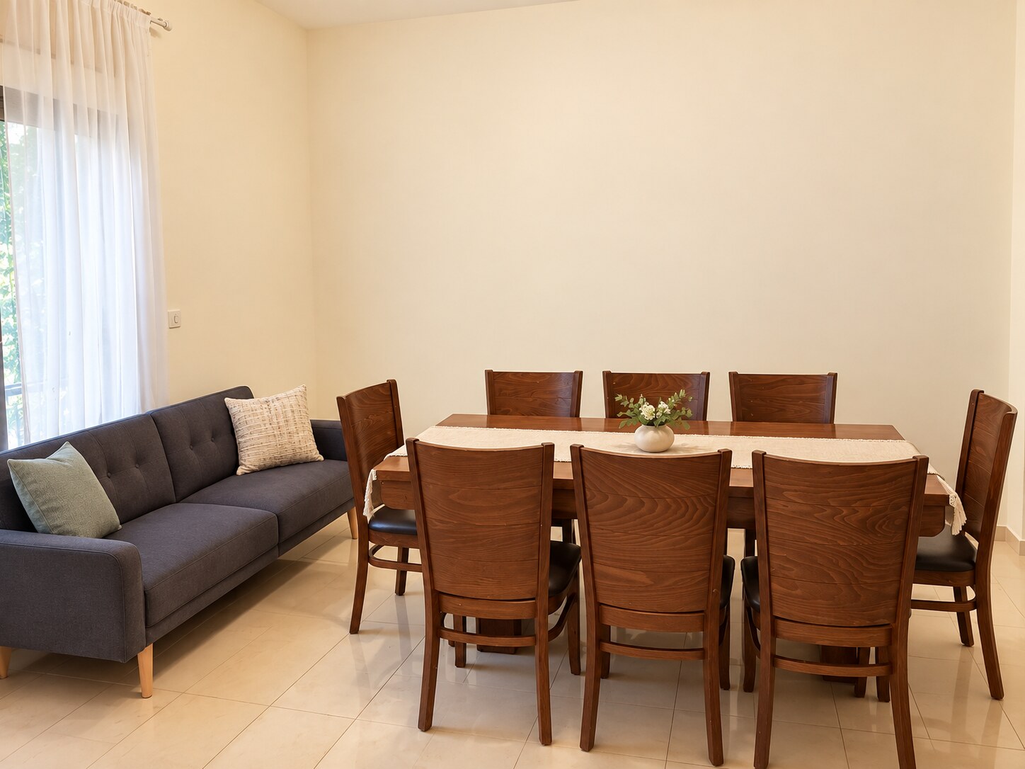 Spacious living and dining room in a three-bedroom Shaarei Chesed Sukkot apartment near KKL and Ussishkin
