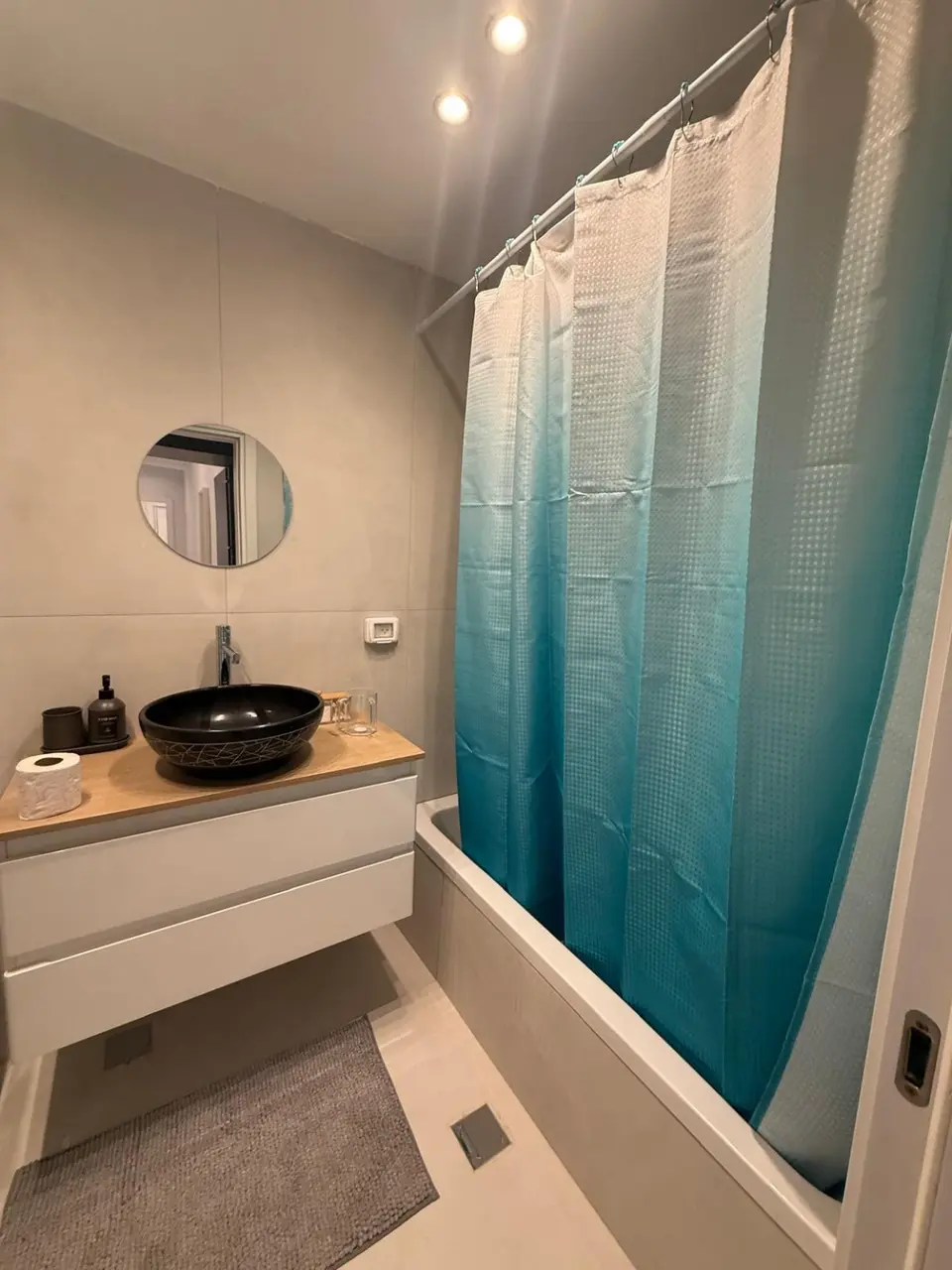 Full bathroom with bathtub and modern vanity in the Ramban Rechavia apartment