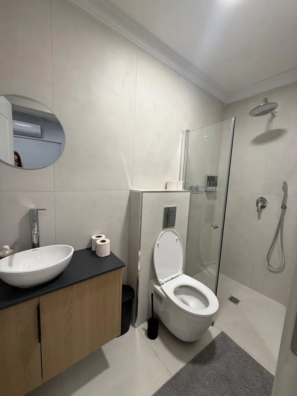 Modern bathroom with a walk-in shower and rain showerhead in the Ramban Rechavia apartment