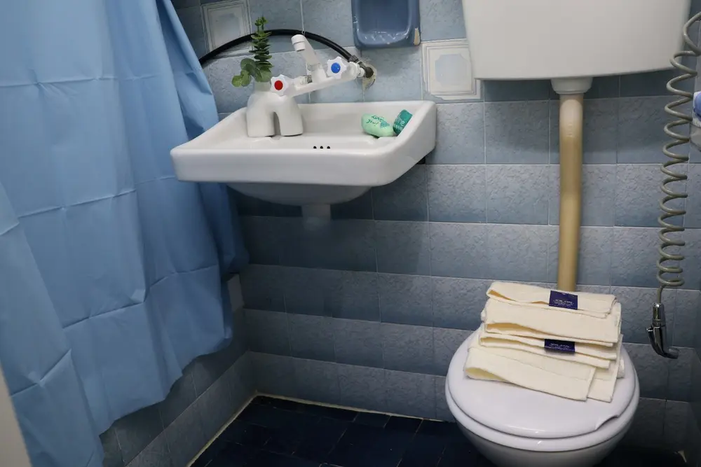Compact full bathroom with shower, toilet and hand basin