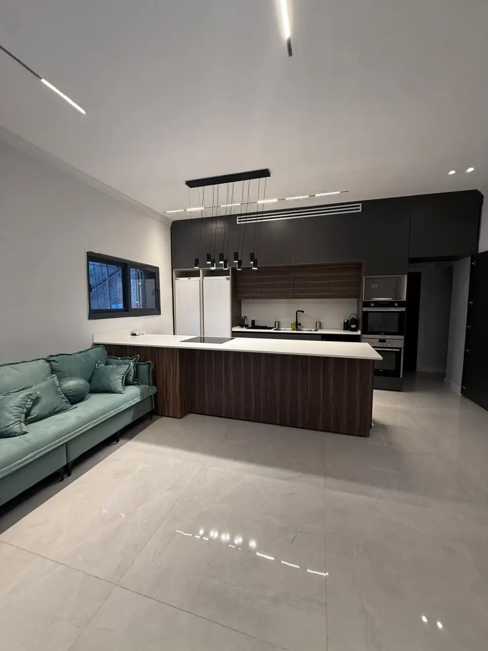 Luxury kosher kitchen with a large island and pendant lighting in the Ramban Rechavia apartment